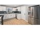 Modern kitchen with white cabinetry, stainless steel appliances, and a stylish backsplash at 362 Brigitte Dr, Northglenn, CO 80260