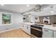 Open kitchen with stainless steel appliances and view of living room with fireplace at 362 Brigitte Dr, Northglenn, CO 80260