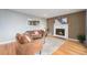 Warm living room with a decorative fireplace, modern wood slat accent wall, hardwood floors, and stylish contemporary furniture at 362 Brigitte Dr, Northglenn, CO 80260