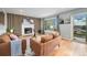 Cozy living room with a fireplace, wood-paneled accent wall, and a sliding glass door at 362 Brigitte Dr, Northglenn, CO 80260