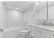 Modern bathroom featuring marble tile surround, updated vanity, and shower-tub combo at 3871 E Euclid Ave, Centennial, CO 80121