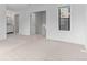 Well-lit bedroom featuring neutral carpet, a bright window, and en suite bathroom at 3871 E Euclid Ave, Centennial, CO 80121