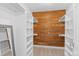 Walk-in closet with custom built in shelving and natural cedar wood accent wall at 3871 E Euclid Ave, Centennial, CO 80121