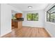 Bright dining area featuring hardwood floors, large windows with scenic views, and a seamless transition to the kitchen at 3871 E Euclid Ave, Centennial, CO 80121