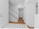Bright entryway featuring tile and wood flooring, a staircase with white railing, and ample closet space at 3871 E Euclid Ave, Centennial, CO 80121