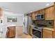 Bright kitchen boasts stainless steel appliances, ample cabinet space and a view to the breakfast nook at 3871 E Euclid Ave, Centennial, CO 80121