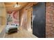 Bedroom nook featuring a brick wall, skylight, black sliding door and designer wallpaper at 825 S Grant St, Denver, CO 80209