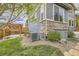 The home has a rock and grass landscaped yard with a stone accented foundation at 11771 W Quarles Ave, Littleton, CO 80127