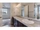 This bathroom features a double sink vanity with modern fixtures and a large mirror at 11771 W Quarles Ave, Littleton, CO 80127