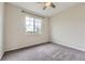Well-lit bedroom with neutral walls, carpet flooring, and a large window for natural light at 11771 W Quarles Ave, Littleton, CO 80127