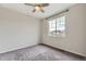 This bedroom features carpet, neutral walls, a ceiling fan, and a large window at 11771 W Quarles Ave, Littleton, CO 80127