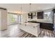 Well-designed kitchen with granite countertops, pendant lighting, and stainless steel appliances at 11771 W Quarles Ave, Littleton, CO 80127