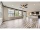 Bright, open-concept living room features large windows and a seamless flow to the kitchen with modern finishes at 11771 W Quarles Ave, Littleton, CO 80127