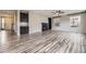 Spacious living room features a cozy fireplace, built-in shelving, and modern flooring throughout at 11771 W Quarles Ave, Littleton, CO 80127