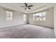 Spacious main bedroom with tray ceiling, ceiling fan, and ample natural light from multiple windows at 11771 W Quarles Ave, Littleton, CO 80127
