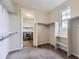 The walk-in closet offers ample shelving and storage space, plus a washer/dryer unit at 11771 W Quarles Ave, Littleton, CO 80127