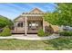 A home exterior features a wooden deck with pergola and stone landscaping at 23426 Briar Leaf Ave, Parker, CO 80138