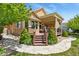 A home exterior displays a wooden deck, pergola, and stone landscaping at 23426 Briar Leaf Ave, Parker, CO 80138