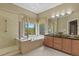 Bright bathroom featuring a glass shower, soaking tub, dual sink vanity, and large window at 23426 Briar Leaf Ave, Parker, CO 80138