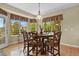 Charming dining room with a round wood table, ample natural light, and outdoor views at 23426 Briar Leaf Ave, Parker, CO 80138