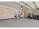 A spacious garage has ample storage with epoxy flooring and modern lighting at 23426 Briar Leaf Ave, Parker, CO 80138