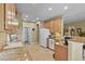 Bright kitchen features stainless appliances, tile floors, and a breakfast bar at 23426 Briar Leaf Ave, Parker, CO 80138