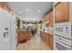 Spacious kitchen with stainless appliances, wood cabinets, and a dining area at 23426 Briar Leaf Ave, Parker, CO 80138