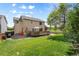 Spacious backyard with a wooden deck, lush lawn, and mature trees at 408 Sylvestor Trl, Highlands Ranch, CO 80129
