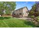 Well-maintained backyard featuring a patio area, deck, and mature landscaping at 408 Sylvestor Trl, Highlands Ranch, CO 80129