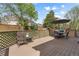 Inviting wooden deck with outdoor seating and shade umbrella at 408 Sylvestor Trl, Highlands Ranch, CO 80129