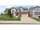 Inviting two-story home featuring a well-maintained lawn and a convenient two-car garage at 408 Sylvestor Trl, Highlands Ranch, CO 80129