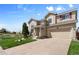Attractive two-story home with attached garage, well-maintained lawn, and charming flower beds at 408 Sylvestor Trl, Highlands Ranch, CO 80129