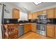 Kitchen with stainless appliances, maple cabinetry, granite countertops and breakfast bar at 408 Sylvestor Trl, Highlands Ranch, CO 80129