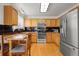 Updated kitchen with stainless steel appliances, wooden cabinetry, and stone countertops with bar seating at 408 Sylvestor Trl, Highlands Ranch, CO 80129