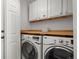 Bright laundry room features a modern washer and dryer with lots of cabinet storage space at 408 Sylvestor Trl, Highlands Ranch, CO 80129