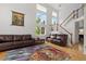 Spacious living room with a staircase, multiple windows, and hardwood floors at 408 Sylvestor Trl, Highlands Ranch, CO 80129
