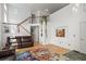 Bright living room with hardwood floors, a staircase, and large windows at 408 Sylvestor Trl, Highlands Ranch, CO 80129