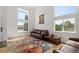 Comfortable living room with a leather sofa, area rug, and ample natural light at 408 Sylvestor Trl, Highlands Ranch, CO 80129