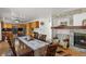 Open-concept living space with a stone fireplace, adjacent to the kitchen and dining areas at 408 Sylvestor Trl, Highlands Ranch, CO 80129