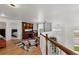 Open loft features built-in desk and shelving with wood floors and staircase at 408 Sylvestor Trl, Highlands Ranch, CO 80129