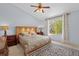 Light-filled main bedroom features a large window, ceiling fan, and plush carpeting at 408 Sylvestor Trl, Highlands Ranch, CO 80129