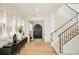 Elegant foyer featuring staircase, hardwood floors, and black entry door with sidelights at 350 Adams St, Denver, CO 80206