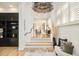Inviting foyer with hardwood floors, a decorative chandelier, staircase, built-in shelving, and abundant natural light at 350 Adams St, Denver, CO 80206
