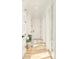 Light-filled hallway with hardwood flooring and a modern chair at 350 Adams St, Denver, CO 80206