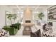 Bright living room with fireplace, hardwood floors, green velvet chairs, and access to the outside via arched glass doors at 350 Adams St, Denver, CO 80206