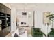 Bright living room featuring a decorative chandelier, large windows with shutters, built-in shelves, and green velvet chairs at 350 Adams St, Denver, CO 80206