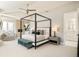 Main bedroom with sitting area, ensuite bath, stone fireplace and a four poster bed at 350 Adams St, Denver, CO 80206