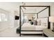 Bright main bedroom with fireplace, four-poster bed and seating area at 350 Adams St, Denver, CO 80206