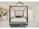 Spacious main bedroom with a four-poster bed, sitting area, and ensuite bathroom at 350 Adams St, Denver, CO 80206
