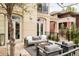 Outdoor patio with a fire pit, comfortable seating, and access to the main house through elegant glass doors at 350 Adams St, Denver, CO 80206